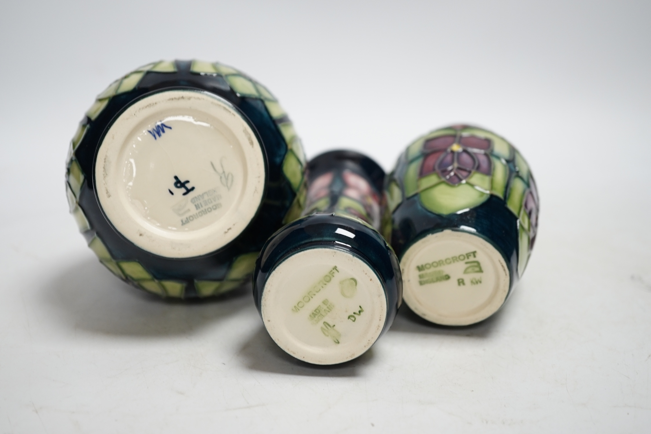 Three Moorcroft violet pattern vases, tallest 13.5cm